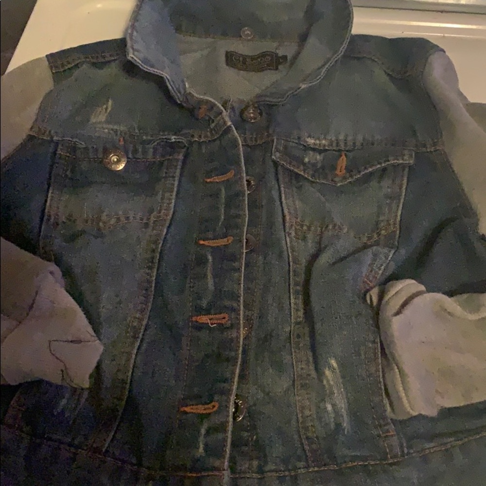 A blue jean and grey jacket